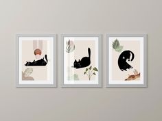 three black cats are hanging on the wall