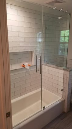 a bathroom with a walk in shower next to a bath tub