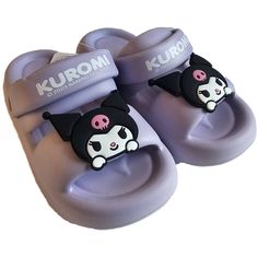 a pair of purple slippers with black and white cat on them