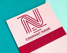 a business card with the letter n on it sitting on top of a blue surface