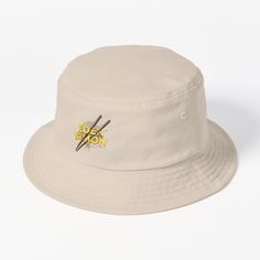 a white bucket hat with scissors on the front and yellow sticker on the side