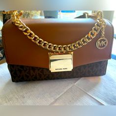 This Is A Mini Michael Kors Bag Very Cute, Only Used It Once, Looks Brand New No Flaws It’s Tan And Black , Have Too Many Bags But Don’t Go Out Much Anymore So I Would Like To Find Them A Good Home! Trendy Michael Kors Brown Shoulder Bag, Trendy Brown Michael Kors Shoulder Bag, Michael Kors Brown Bag With Chain Strap, Mini Accessories, Michael Kors Accessories, Black Tan, Go Out, Michael Kors Bag, Black And Tan