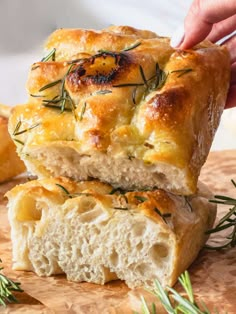 two pieces of bread with rosemary sprigs on top and one piece cut in half