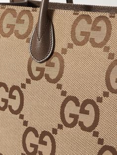 Gucci's neat rectangular tote bag is crisscrossed with the label's new maximalist take on the 'GG' monogram. It's panelled from canvas with leather through the top handles, sides and base and fitted with an optional webbing shoulder strap, too. Designer Beige Shoulder Bag With Logo, Classic Gucci Shoulder Bag With Logo, Gucci Shoulder Bag With Logo And Top Handle, Gucci Coated Canvas Bag With Logo, Modern Gucci Shoulder Bag With Logo, Modern Shoulder Bag With Monogram Print For Everyday Use, Modern Monogram Print Shoulder Bag For Everyday Use, Luxury Logo Tote Shoulder Bag, Modern Gucci Shoulder Bag For Shopping