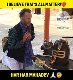 a man sitting on the ground next to an elephant statue with words above it that read, i believe that's all matter