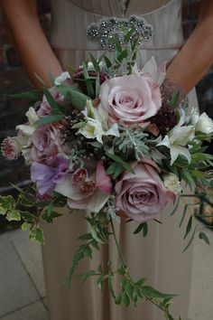 a woman holding a bouquet of flowers in her hands