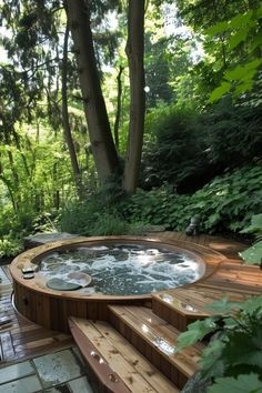 an outdoor hot tub in the middle of a wooden deck surrounded by trees and bushes