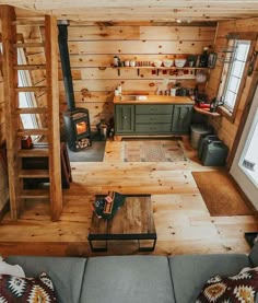 a living room filled with furniture and a fire place in the middle of a room