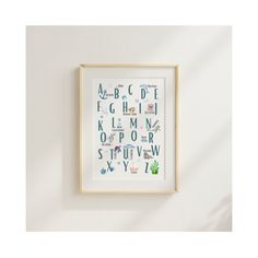 a framed alphabet print hanging on the wall