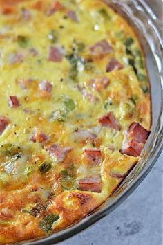 an omelet with ham, broccoli and cheese in a glass dish