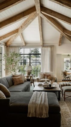 a living room filled with furniture and a fire place in the middle of a room