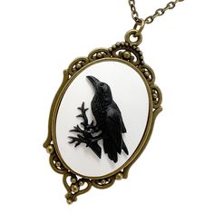 "This stylish gothic style necklace features a unique cameo pendant. While walking down the famed Takeshita Dori street with this unusual aesthetic cameo necklace you will be King or Queen of the crowd. It is unique handmade jewellery gift for a women, men, goth, punk, Steampunk, Harajuku, and visual kei fashion fans. This trendy jewelry necklace comes in a complimentary gift box, the only thing you need to add is a card and your present is ready! Antique bronze, goth style pendant setting is about 2\" x 1-1/2\" with black raven on white resin. Necklace chain is 24\" long, bronze tone color, lead and nickel safe. Make a bold statement with our handcrafted gothic jewelry by UMBRELLALABORATORY" Gothic Black Brass Necklace, Black Gothic Brass Necklace, Gothic Cameo Necklaces For Gifts, Gothic Cameo Necklaces As Gift, Gothic Cameo Necklace As Gift, Gothic Cameo Necklace For Gift, Unusual Aesthetic, Takeshita Dori, Punk Steampunk