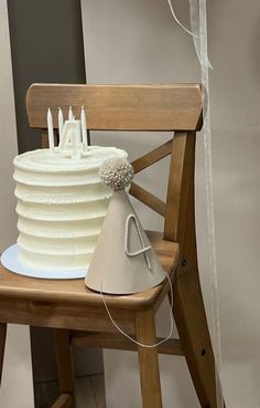 a white cake sitting on top of a wooden chair