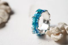 Beautiful ring Wave will bring you back to the sea! This ring is unique! Using hot enamel technique every item receives his own unique texture! https://www.etsy.com/listing/559371911/ - Wide wave ring (10 mm) Details: Width: 5mm Thickness: 1.2 mm Materials: sterling silver 925, hot vitreous enamel These rings in gold: https://www.etsy.com/listing/932462309/ - Gold blue wave https://www.etsy.com/listing/932465221/ - Gold green wave Please provide me size of the ring during the order, thank you! T Ocean-inspired Promise Ring, Ocean-inspired Blue Ring For Gift, Ocean-inspired Blue Ring For Gifts, Ocean-inspired Blue Rings As Gifts, Ocean-inspired Sterling Silver Jewelry For Wedding, Ocean-inspired Sterling Silver Jewelry For Weddings, Ocean-inspired Round Ring For Anniversary, Ocean-inspired Blue Jewelry For Anniversary, Blue Ocean-inspired Jewelry For Anniversary