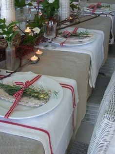 the table is set with plates and candles