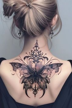 the back of a woman's neck with an intricate butterfly tattoo on her chest