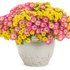 a white vase filled with yellow and pink flowers