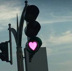 a traffic light with a pink heart on it