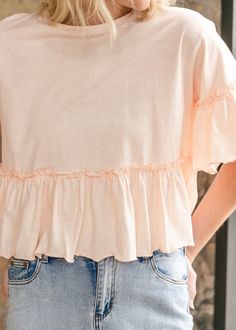 The Taytum Ruffle Sleeve Peplum Top is feminine and modest top that pairs perfectly with denim. Crafted from 100% cotton in a sunwashed peach hue perfect for this season. It has a feminine peplum silhouette with ruffle sleeves, and a modest crewneck. Just add denim and sneakers for a pretty everyday outfit. Style: Peplum, Short Sleeve Color: Peach SIZING TIPS Fit | Loose Fit Stretch | None Our Model wore True to Size. Trendy Cotton Top With Ruffle Hem, Cotton Top With Ruffle Hem For Day Out, Cotton Tops With Ruffle Hem For Day Out, Cotton Tops With Ruffle Hem For Summer, Light Wash Cotton Tops For A Day Out, Casual Ruffle Hem Top For Brunch, Soft-washed Pink Top For Spring, Light Wash Tops For Spring Day Out, Light Wash Summer Top For Brunch