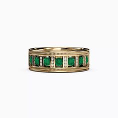 a gold ring with emeralds and diamonds