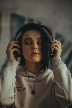 a young woman wearing headphones listening to music