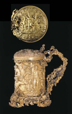 an ornately decorated coffee pot with a gold lid