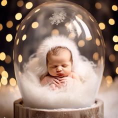 a baby in a snow globe with lights behind it