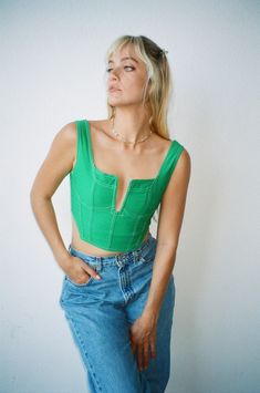 Stylist Pick! The Luck Is On Your Side Top features a corset silhouette with cropped length, contrast stitching, exposed back zipper and tank style sleeves. Color: Green Plunging Cut Out Neckline Tank Style Sleeve Contrast Stitching Exposed Zipper Back Zipper Cotton Model Wearing Size Medium and is 5'7" Tall, 32A Bust, 26 In Bottoms Cropped Tops With Boned Bodice For Night Out, Trendy Cropped Top With Corset Back, Trendy Tops With Boned Bodice For Night Out, Trendy Cropped Crop Top With Corset Back, Cropped Zipper Closure Crop Top For Night Out, Cropped Crop Top With Zipper Closure For Night Out, Spring Club Tops With Zipper Closure, Fitted Green Tops With Zipper Closure, Spring Crop Top With Zipper For Night Out