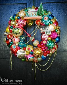 a christmas wreath with ornaments hanging from it