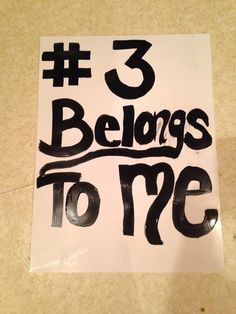 a sign that says 3 belongs to me on the floor in front of a wall