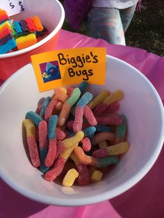 there is a bowl full of gummy bears and a sign that says buggie's bugs