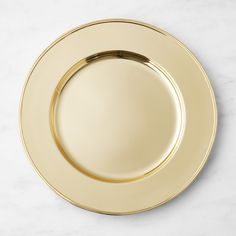 an empty gold plate on a marble surface