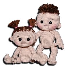 two crocheted dolls sitting next to each other