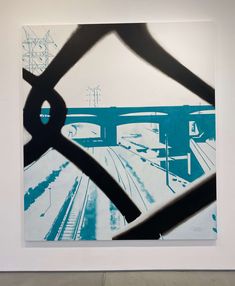 an abstract painting on display in a white walled room with blue and black artwork hanging from the wall