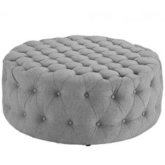 a round ottoman with buttons on it