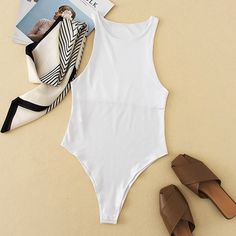 Cool & Chic. Style this bodysuit with your fave pair of jeans, pastel mules & layered gold hoops for a go-to date night look. Lightweight / Stretch 100% Polyester Cold Hand Wash / Cool Iron Featuring a clip up the bottom Imported Shiny Skirts, Chain Skirt, Slim Jumpsuit, Chic Skirts, Body Top, Sleeveless Bodysuit, Night Looks, Casual Streetwear, Gold Hoops