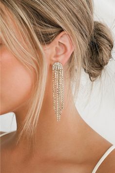 The Petit Moments Glitz Gold Rhinestone Tassel Earrings are just the kind of look that we wanna wear out (and get noticed in)! Elegant strands of shiny gold snake chain and clear rhinestone chains cascade from post backs. Pair with your favorite LBD and you'll easily make it a night to remember! Post backs. 3. 25" Long. 40% Zinc Alloy, 60% Glass. Imported. Lulus | Glitz Gold Rhinestone Tassel Earrings. Gold Earrings For Black Dress, Gold Hoco Jewelry, Formal Jewelry Gold, Prom Earrings Gold, Hoco Jewelry, Homecoming Jewelry, Rhinestone Tassel Earrings, Prom Gold, Hoco 2024