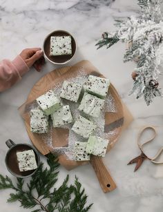 a wooden cutting board topped with pieces of cake