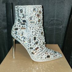 Beautiful Eye-Catching Steve Madden Bootie, Just In Time For The Holidays. This Boot Is New And Has Never Been Worn. Comes With Original Box And Extra Rhinestones. Shoe Size Is Listed As 7 But Fits Like 6.5 Silver Embellished Wedding Boots, Embellished Silver Wedding Boots, Glamorous White Embellished Boots, Glamorous High Heel Boots With Silver Studs, Luxury Silver High Heel Boots, Elegant Silver Ankle Boot Heels, Silver Crystal Heels With Pointed Toe, Glamorous Silver Pointed Toe Boots, Glamorous Metallic Silver High Heel Boots