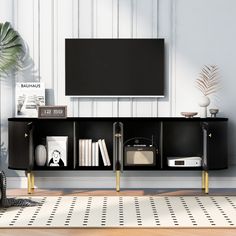 a living room with a large tv mounted on the wall next to a book shelf