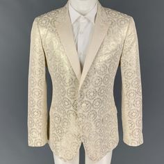 Dolce & Gabbana Sport Coat Comes In A Beige & Silver Jacquard Acetate Blend With A Full Liner Featuring A Peak Lapel, Flap Pockets, Single Back Vent, And A Single Button Closure. Made In Italy. Very Good Pre-Owned Condition. Marked: 52 Measurements: Shoulder: 18 Inches Chest: 42 Inches Sleeve: 26.5 Inches Length: 28.5 Inches Sui Generis Reference: 120621 Category: Sport Coat More Details Brand: Dolce & Gabbana Size: 42 Chest Size: 42 Gender: Male Color: Beige Color 2: Silver Pattern: Jacquard Fabric: Acetate Blend Style: Peak Lapel Made In: Italy Age Group: Adult Sui Generis Designer Consignment Is An Award Winning Fashion Resale Store For Women & Men. Dolce And Gabbana Suits, Resale Store, Wedding Jacket, Peak Lapel, Consignment Stores, Jacquard Fabric, Dolce & Gabbana, Color 2, Chest Size