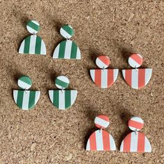 These orange/white and green/white statement earrings are inspired by the beach umbrellas on the coasts of Italy. The graphic stripe gives you a taste of summer that is also a perfect complement to your outfit in any season. Offered in a variety of styles.  As these are handmade, there may be slight variations in size, shape, and color with each earring or minor imperfections. These earrings are handcrafted with polymer clay (and love). Please handle with care: * while durable and bendable, plea White Statement Earrings, Gem Tones, Italian Coast, Striped Earrings, Earrings Green, Orange White, Cute Earrings, Amalfi, Green And Orange