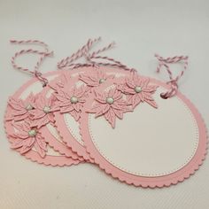 three tags with pink flowers on them