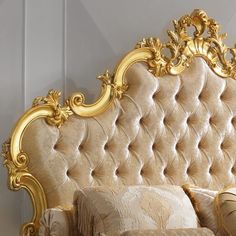 an ornate gold headboard and pillows in a bedroom