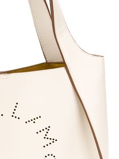 Best friends come in all shapes and sizes - it just so happens that this one comes in the form of a Stella McCartney small logo tote. Crafted from white faux leather, this hero piece keeps it nice and simple, with a minimal design decorated only by the perforated logo to the front. A friend for life. Featuring top handles, a detachable shoulder strap, a magnetic fastening, a removable pouch and a perforated logo design to the front. POSITIVELY CONSCIOUS: We’ve joined forces with ethical agency G Beige Top Handle Shoulder Bag With Logo, Beige Logo Tote Shoulder Bag, Cream Logo Tote Shoulder Bag, Cream Tote Shoulder Bag With Logo, Leather Shoulder Bag With Logo For On-the-go, Beige Leather Shoulder Bag With Logo, White Leather Shoulder Bag With Logo, Designer Cream Shoulder Bag With Logo, Everyday Leather Shoulder Bag With Logo