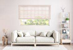 a white couch sitting in front of a window