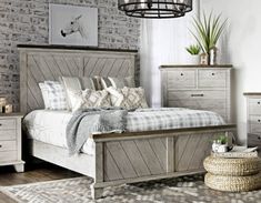 a bedroom with brick walls and white furniture