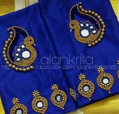 two pieces of blue fabric with gold and white beads on it, one piece has an intricate