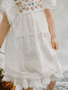 Introducing the Arya Mini Dress - the timeless must-have of the season! Featuring a white -colored dress with intricate embroidery and pom pom details, your little princess will look like she stepped out of a fairytale. Layer the dress over their favorite leggings for a pop of color and a classic yet modern flair - perfection! Dress is a mini Lay flat to dry or tumble dry low and remove promptly Some shrinkage may occur if tumble tried 100% cotton Diy Embroidery Flowers, Baby Dress Embroidery, Favorite Leggings, Hand Embroidery Dress, Boutique Ideas, Sibling Gifts, Clothing Boxes, Facebook Style, Dress Embroidery