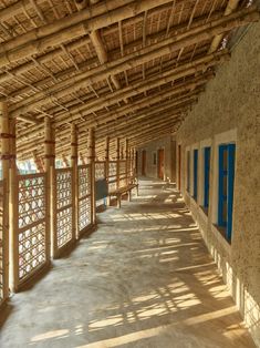 the inside of a building with blue shutters and windows on each side of it